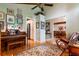 Inviting living room featuring a piano, ceiling fan, and hardwood floors at 6226 Wynfield Court, Orlando, FL 32819