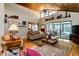 Bright living room with vaulted ceilings, decor shelving, and views of the pool area at 6226 Wynfield Court, Orlando, FL 32819