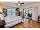 Bright main bedroom boasts hardwood floors, ceiling fan, and sliding glass doors to outdoor living space at 6226 Wynfield Court, Orlando, FL 32819