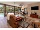 This home features a screened in patio with a ceiling fan, comfortable furniture and a view of the pool at 6226 Wynfield Court, Orlando, FL 32819