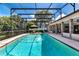 A long, screened in pool area with clear blue water and a patio for outdoor entertaining at 6226 Wynfield Court, Orlando, FL 32819