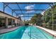 Screened-in pool with a clear blue water and a spacious seating area, perfect for relaxing outdoors at 6226 Wynfield Court, Orlando, FL 32819