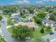 Aerial view of neighborhood with mature trees, well-maintained lawns, and community pool at 6630 Hidden Beach Cir, Orlando, FL 32819