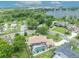 Beautiful aerial view showcases a single-Gathering home with a screened pool, lush backyard, and mature trees at 6630 Hidden Beach Cir, Orlando, FL 32819