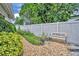 Serene backyard with gravel path, bench, and lush greenery at 6630 Hidden Beach Cir, Orlando, FL 32819