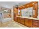 Luxurious bathroom with dual vanities, granite countertops, a soaking tub, and custom cabinetry at 6630 Hidden Beach Cir, Orlando, FL 32819