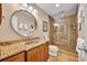 Updated bathroom with granite vanity and large walk-in shower with glass door at 6630 Hidden Beach Cir, Orlando, FL 32819