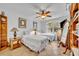 Bright bedroom featuring two beds, ceiling fan, and dresser with mirror at 6630 Hidden Beach Cir, Orlando, FL 32819