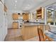 Cozy kitchen features tile floors, granite counters, and natural wood cabinets with ample storage space at 6630 Hidden Beach Cir, Orlando, FL 32819