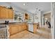 Well-lit kitchen features tile flooring, wooden cabinets, granite countertops, and a view to the back yard at 6630 Hidden Beach Cir, Orlando, FL 32819