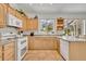Bright kitchen with light wood cabinetry, granite countertops, and large windows offering natural light at 6630 Hidden Beach Cir, Orlando, FL 32819
