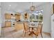 Charming eat-in kitchen featuring light wood cabinets, granite countertops, tile flooring, and a bright dining area at 6630 Hidden Beach Cir, Orlando, FL 32819
