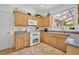 A well-maintained kitchen with tile flooring, granite countertops, and a view of the backyard at 6630 Hidden Beach Cir, Orlando, FL 32819