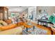 Open-concept living area featuring hardwood floors, comfortable seating, and seamless flow into the dining space at 6630 Hidden Beach Cir, Orlando, FL 32819