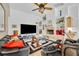 Bright and airy living room featuring a fireplace, tile flooring, and access to the outdoor area at 6630 Hidden Beach Cir, Orlando, FL 32819