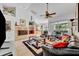 Cozy living room with a fireplace, tile flooring, and comfortable seating, creating a relaxing ambiance at 6630 Hidden Beach Cir, Orlando, FL 32819