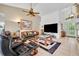 Spacious living room with high ceilings, tile flooring, and a comfortable seating arrangement at 6630 Hidden Beach Cir, Orlando, FL 32819