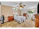 Tranquil main bedroom features vaulted ceilings, neutral tones, and ample natural light from the large window at 6630 Hidden Beach Cir, Orlando, FL 32819