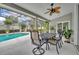 Outdoor dining area on screened patio overlooking the pool at 6630 Hidden Beach Cir, Orlando, FL 32819