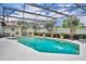 A screened-in private pool with lush landscaping, perfect for relaxing and entertaining outdoors at 6630 Hidden Beach Cir, Orlando, FL 32819