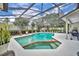 Beautiful pool area with screened enclosure, pool, spa, and outdoor seating at 6630 Hidden Beach Cir, Orlando, FL 32819