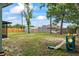 Spacious backyard features a new fence, mature trees, a hammock, a swing set, and plenty of space for outdoor activities at 705 Ibis Ave, Deltona, FL 32738