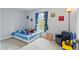 Bright bedroom featuring a bed, chair and natural light with fun colorful decor at 705 Ibis Ave, Deltona, FL 32738
