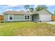 Charming single-story home with a well-kept lawn and convenient two-car garage at 705 Ibis Ave, Deltona, FL 32738