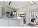Bright kitchen featuring gray cabinets, stainless steel appliances, a large bay window, and modern countertops at 705 Ibis Ave, Deltona, FL 32738