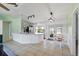 Open-concept kitchen and dining area with stainless steel appliances and sliding glass doors to the backyard at 705 Ibis Ave, Deltona, FL 32738