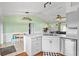 Well-lit kitchen with modern cabinetry, a spacious island with seating, and views into the living room at 705 Ibis Ave, Deltona, FL 32738