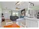 Bright, open-concept living room with a stylish fireplace and an adjacent kitchen at 705 Ibis Ave, Deltona, FL 32738