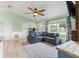 Bright living room featuring a large sectional couch with natural light at 705 Ibis Ave, Deltona, FL 32738