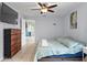 Spacious main bedroom featuring a ceiling fan, a mounted TV, and tiled floors at 705 Ibis Ave, Deltona, FL 32738