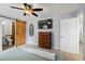 Relax in the main bedroom, complete with a ceiling fan, ensuite bath, and mounted television at 705 Ibis Ave, Deltona, FL 32738