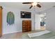 The spacious main bedroom is complete with a ceiling fan, dresser, and lots of natural light at 705 Ibis Ave, Deltona, FL 32738