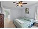 This main bedroom has a ceiling fan, tiled floors, and lots of natural light at 705 Ibis Ave, Deltona, FL 32738
