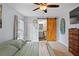 The main bedroom offers a ceiling fan, access to an ensuite bath, and lots of natural light at 705 Ibis Ave, Deltona, FL 32738