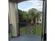 Balcony view overlooking tropical landscaping and palm trees, creating a serene and private outdoor retreat at 7230 Westpointe Blvd # 1235, Orlando, FL 32835