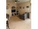 Comfortable living room featuring a ceiling fan and built-in shelves for decor at 7230 Westpointe Blvd # 1235, Orlando, FL 32835