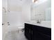 Bathroom features a white tiled tub/shower, single vanity, and a framed mirror at 7530 Summerlake Groves St, Winter Garden, FL 34787