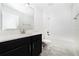 This bathroom features a dark vanity with a white countertop and shower at 7530 Summerlake Groves St, Winter Garden, FL 34787