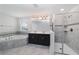 Luxurious bathroom featuring a separate glass shower, soaking tub, and a double vanity at 7530 Summerlake Groves St, Winter Garden, FL 34787