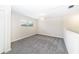 Neutral-toned room featuring soft carpet, abundant natural light, and a minimalist style at 7530 Summerlake Groves St, Winter Garden, FL 34787
