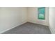 This bedroom offers neutral walls and carpeting with a window view at 7530 Summerlake Groves St, Winter Garden, FL 34787