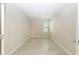 A bright bedroom with neutral walls and tiled floor; a window provides natural light at 7530 Summerlake Groves St, Winter Garden, FL 34787