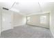 Spacious bedroom features plush neutral carpeting, a tray ceiling, and natural light from multiple windows at 7530 Summerlake Groves St, Winter Garden, FL 34787