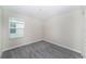 Cozy bedroom with a window bringing in natural light and neutral-toned walls and gray carpet at 7530 Summerlake Groves St, Winter Garden, FL 34787