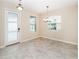 Bright, minimalist dining room with tile flooring and lots of natural light from multiple windows at 7530 Summerlake Groves St, Winter Garden, FL 34787