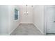 Dining room features tile floors, a window, and a modern chandelier at 7530 Summerlake Groves St, Winter Garden, FL 34787